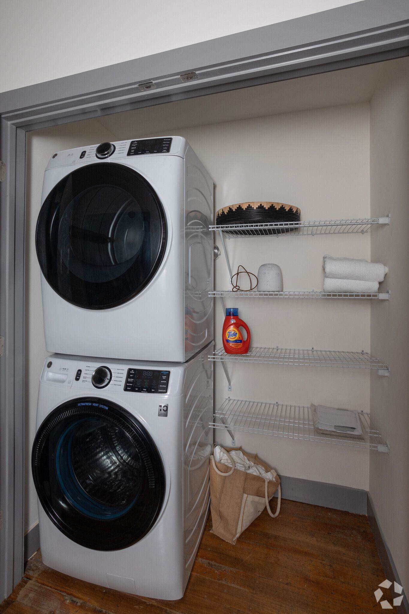 A washer and dryer are stacked on top of each other in a laundry room.