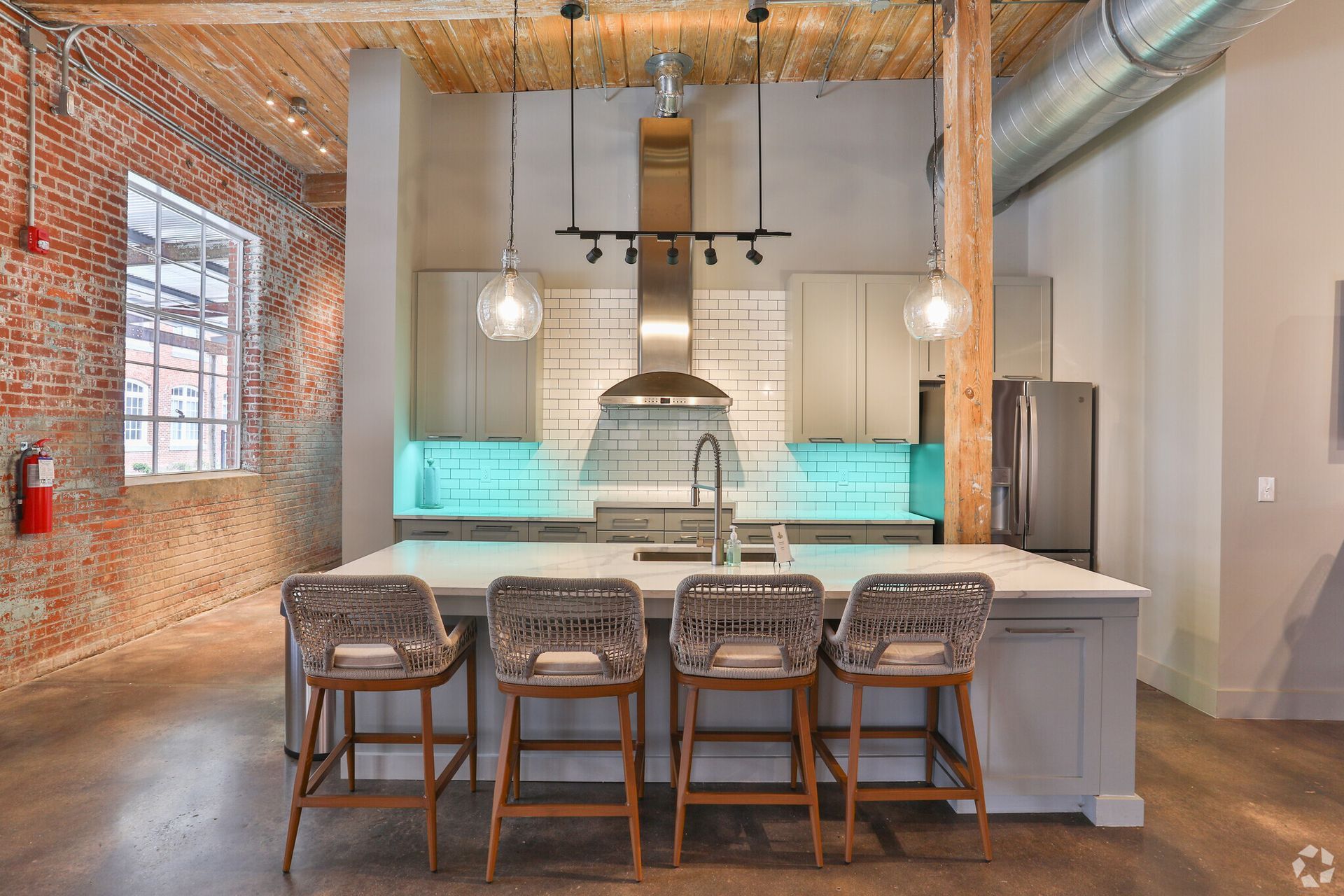 A kitchen with a large island and stools.