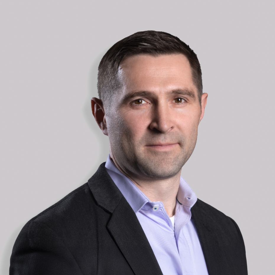 A man in a blue suit and white shirt is posing for a picture.