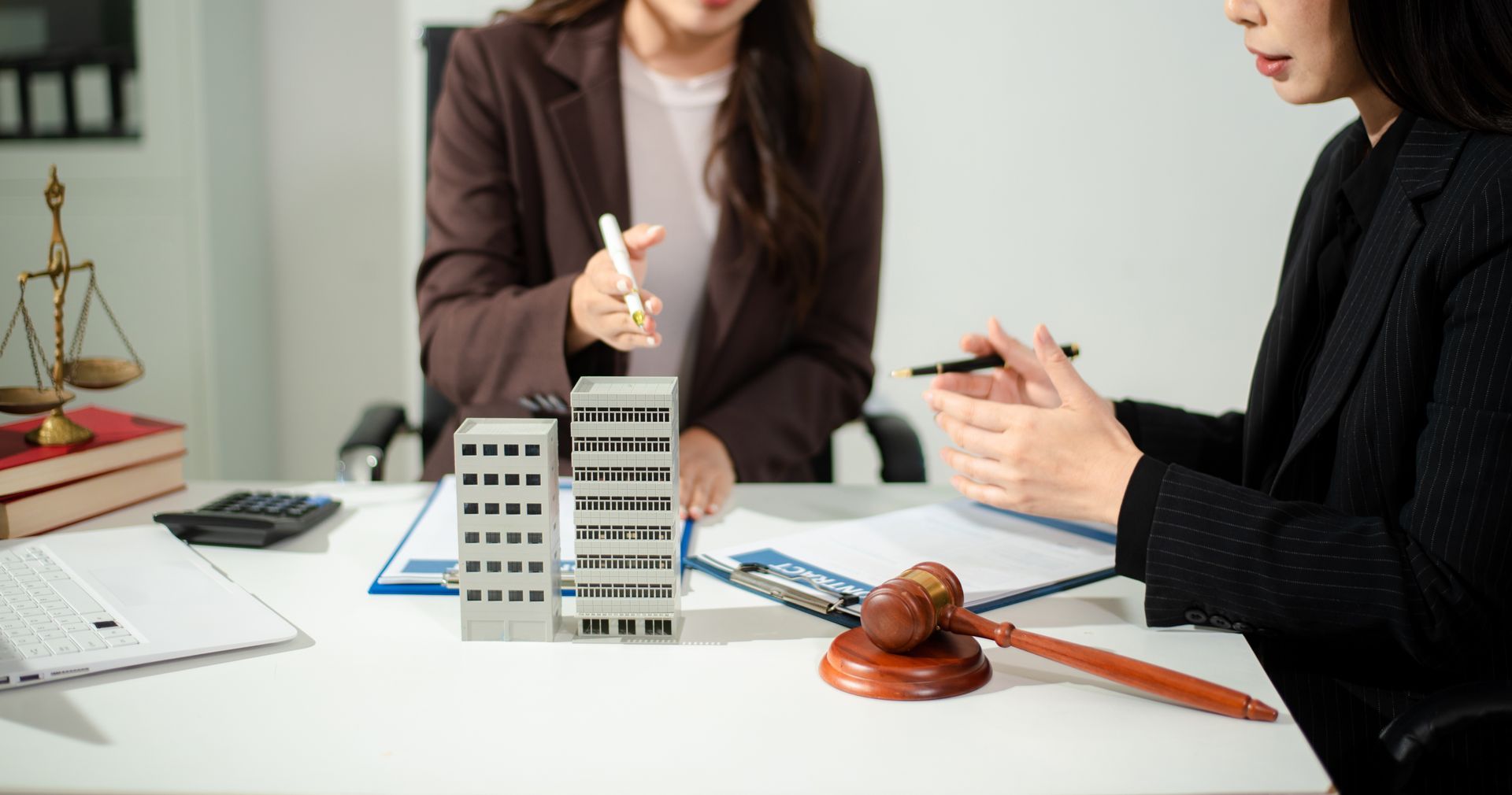 An estate lawyer reviewing probate and estate planning documents at a desk.