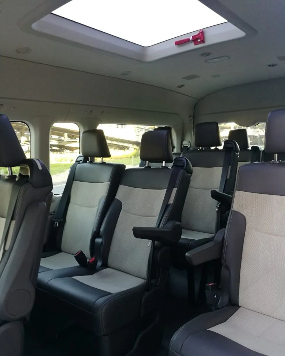 The inside of a van with a skylight above the seats