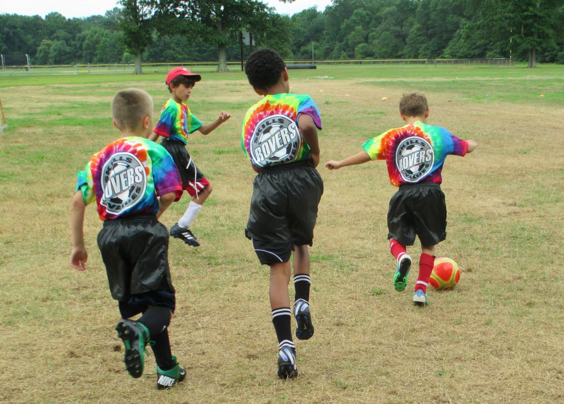 a group of young boys are playing soccer on a field