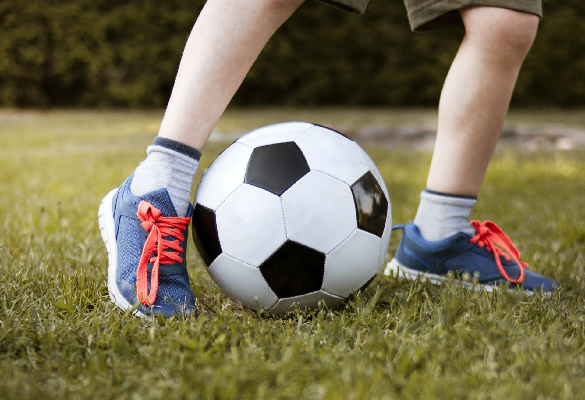 a group of children are running on a soccer field