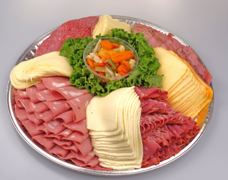 A silver tray filled with sliced meats and cheeses