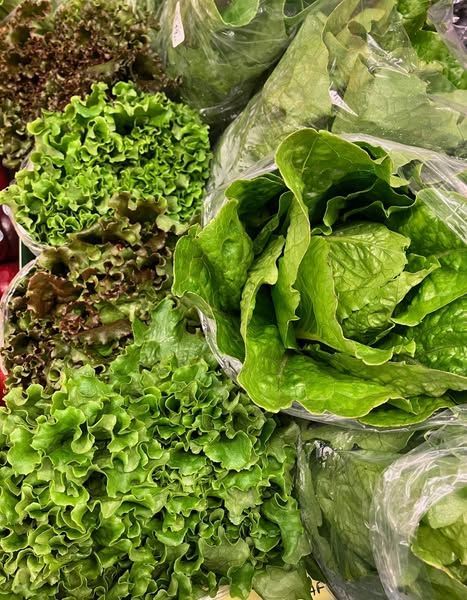 A bunch of lettuce leaves are sitting on top of each other on a table.