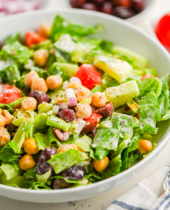 A close up of a salad in a bowl on a table.