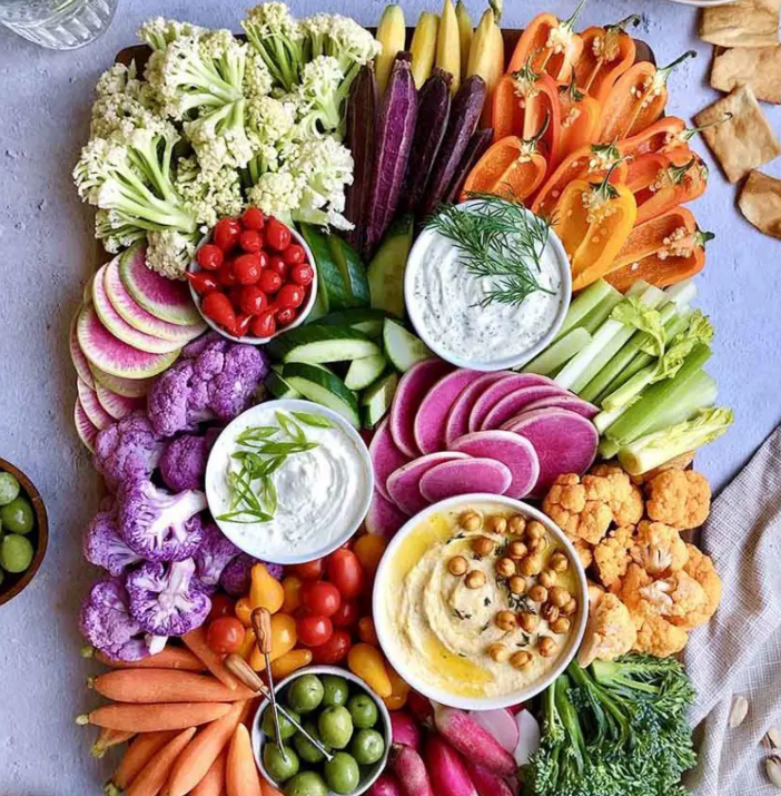 A variety of vegetables and dips on a plate