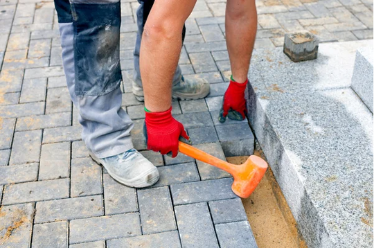 Paver with hammer