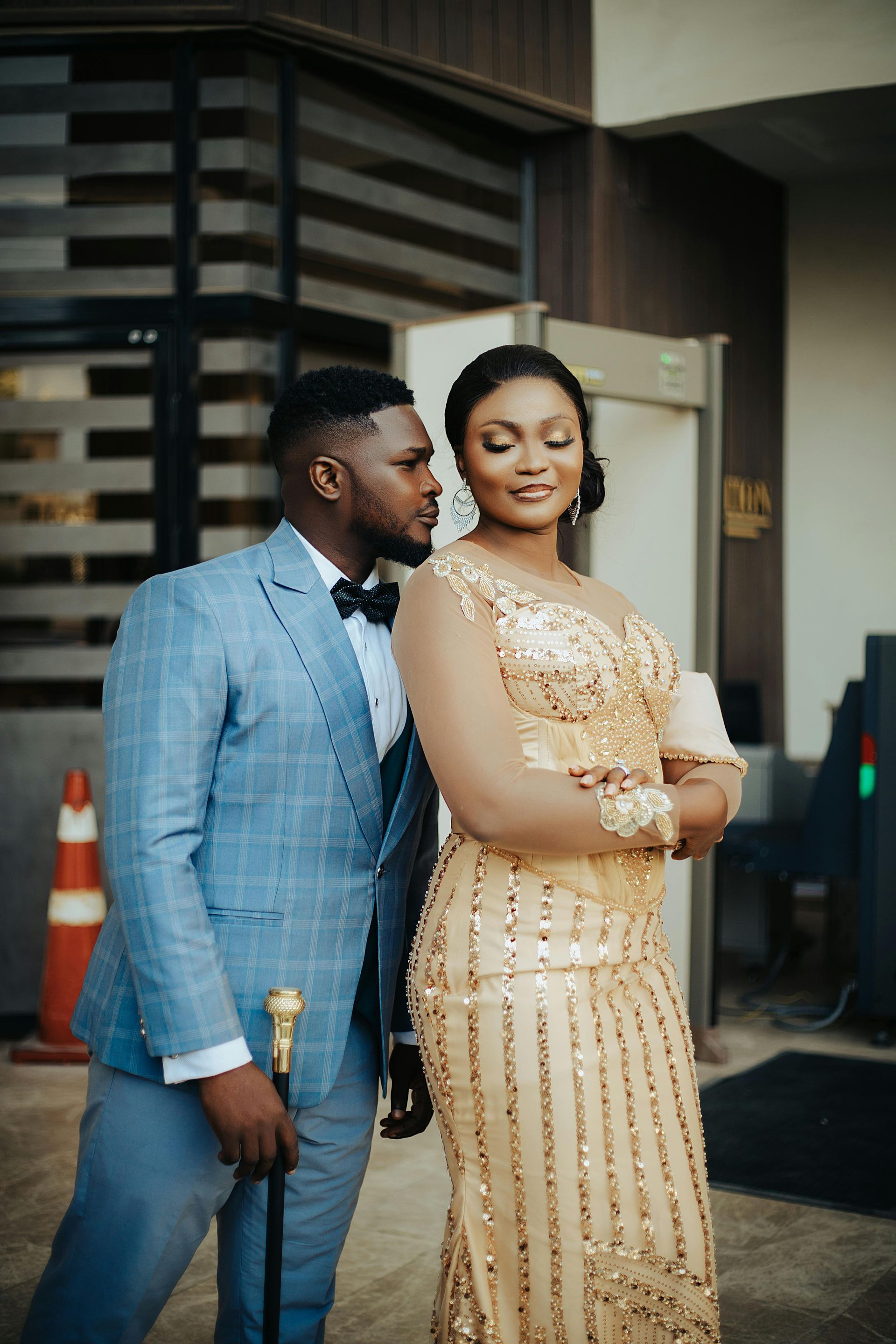 A man and a boy are standing next to each other on a wooden table.