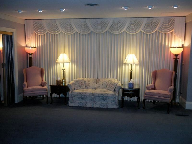 A living room with a couch and two chairs