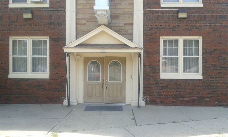 A brick building with a canopy over the entrance