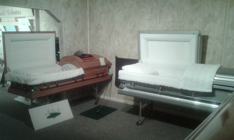 Two coffins are sitting on a table in a room.