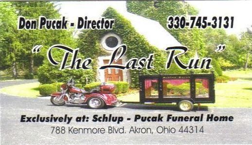 A motorcycle is pulling a trailer that says the last run