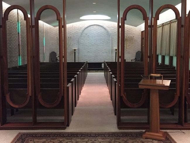 a church with rows of pews and a podium in the middle