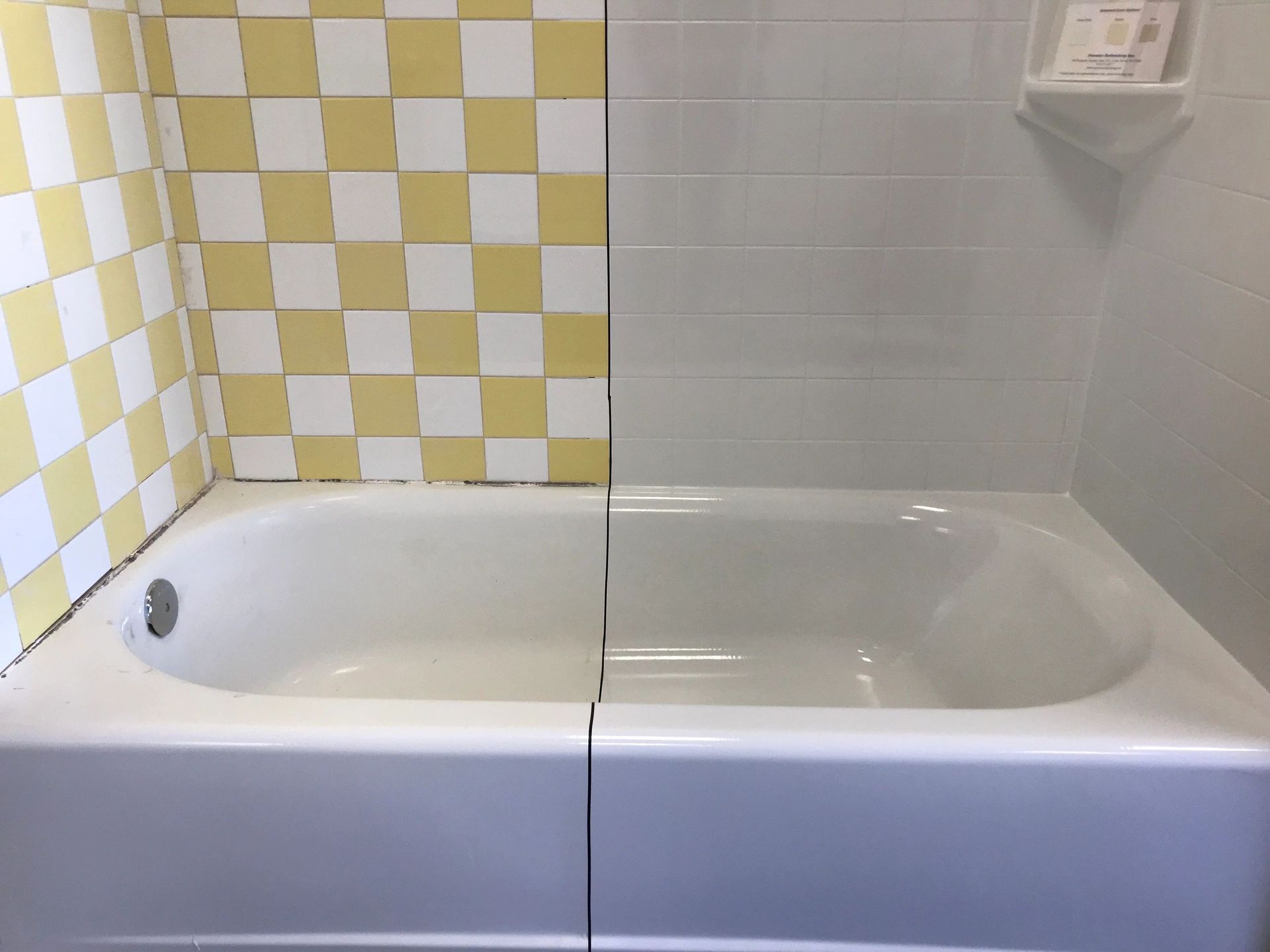 A bathtub in a bathroom with yellow and white checkered tiles.