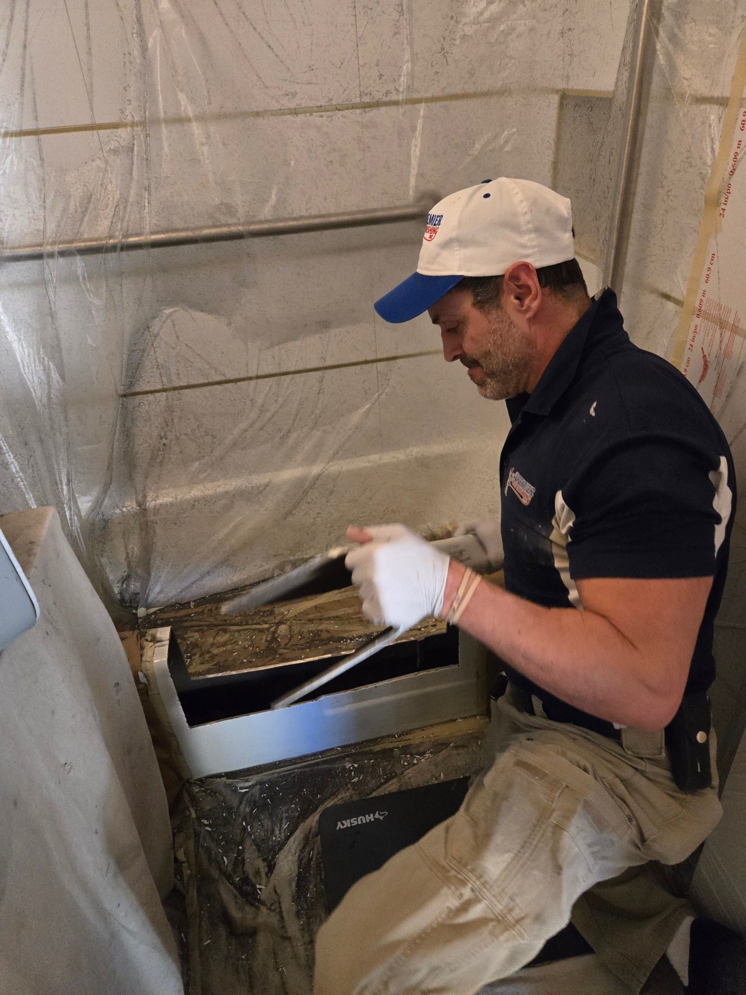 A bathroom with a bathtub and handrails on the wall.