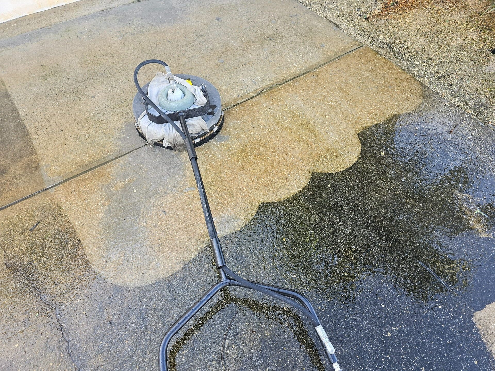 Woman in straw hat smiles, holding wine glass near a lake.