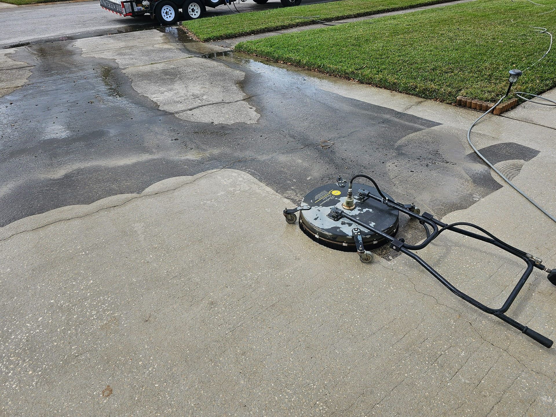 Woman in straw hat smiles, holding wine glass near a lake.