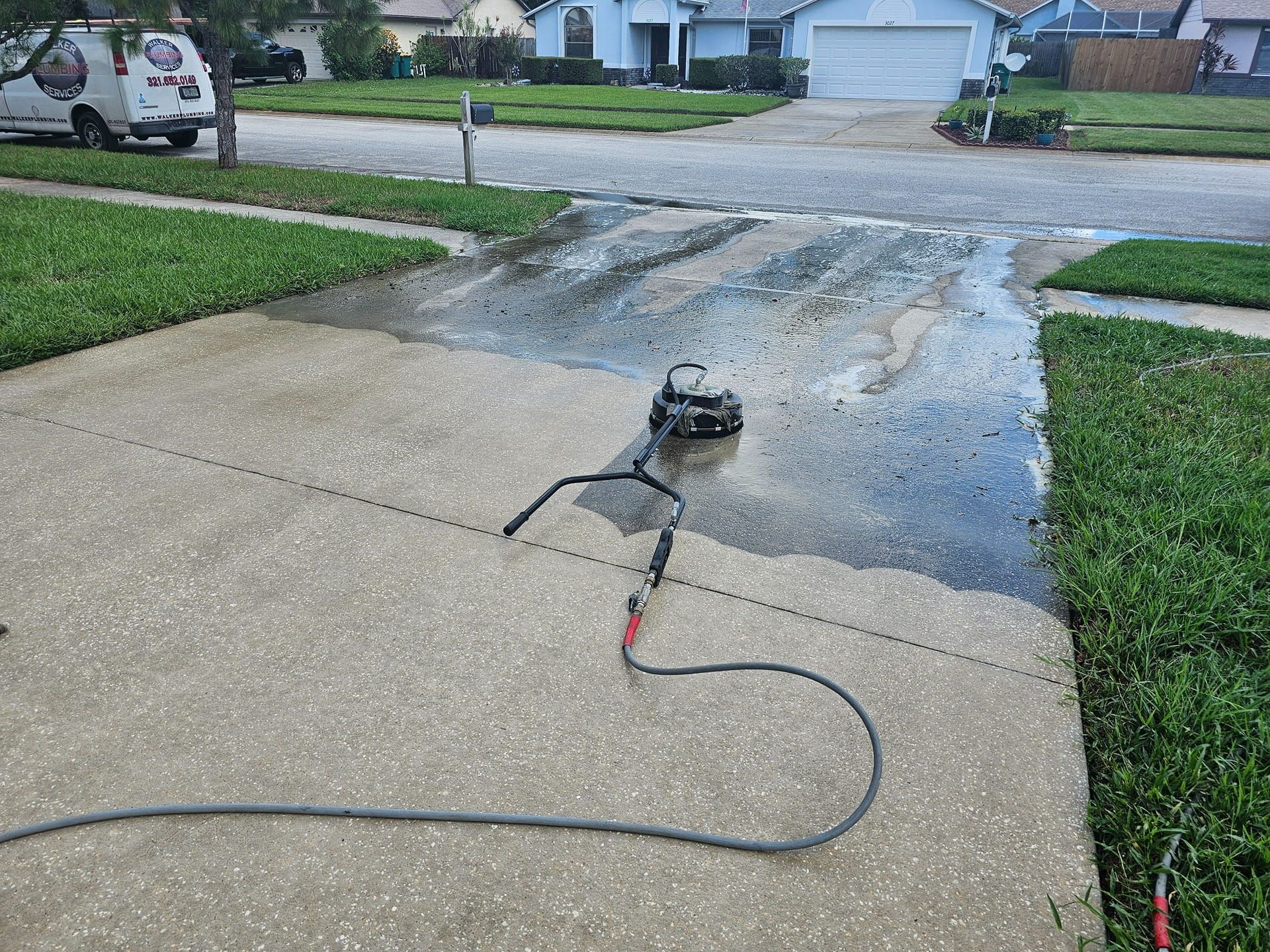 Woman in straw hat smiles, holding wine glass near a lake.