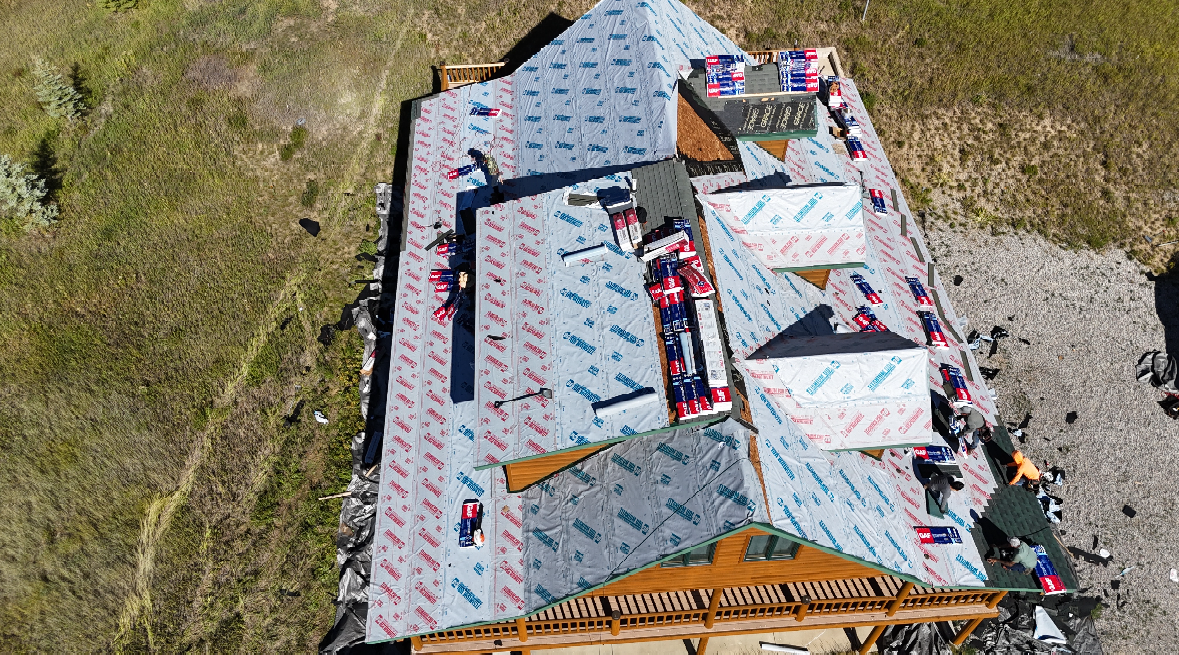 An aerial view of a roof being installed on a house.