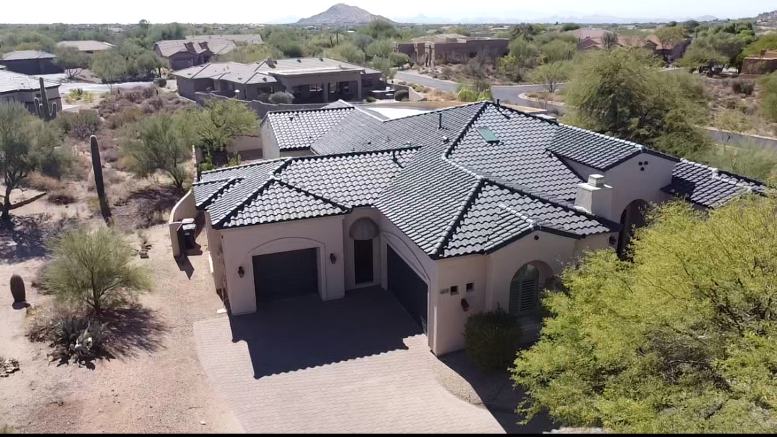 An aerial view of a large house with a tiled roof