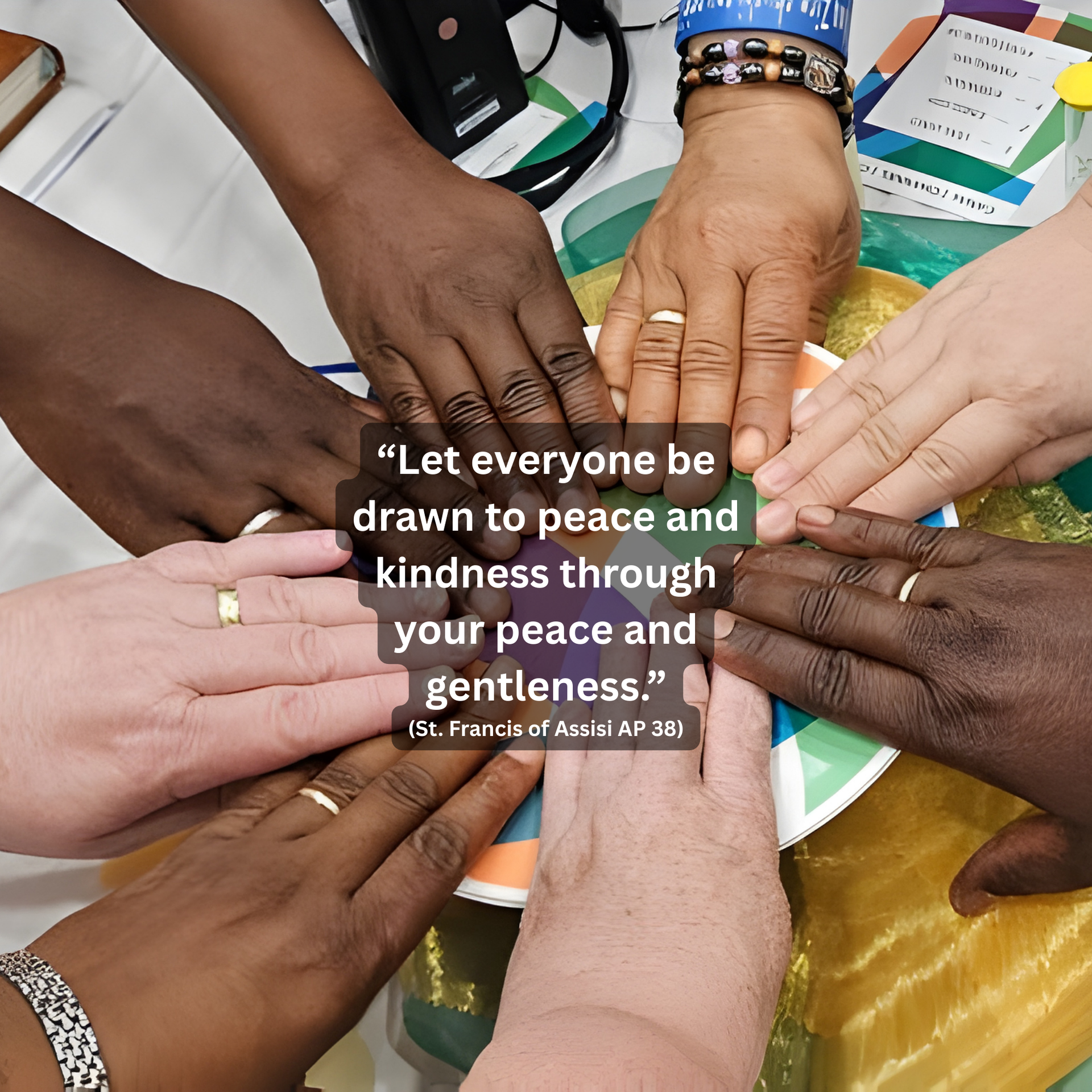 Several hands of diverse skin tones are placed together in a circle over a paper plate with an inspirational quote.