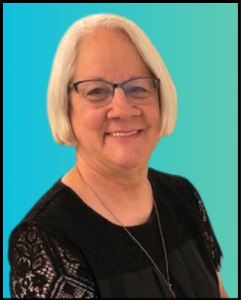 Smiling person with short white hair and glasses wearing a black lace-sleeved top against a blue gradient background.