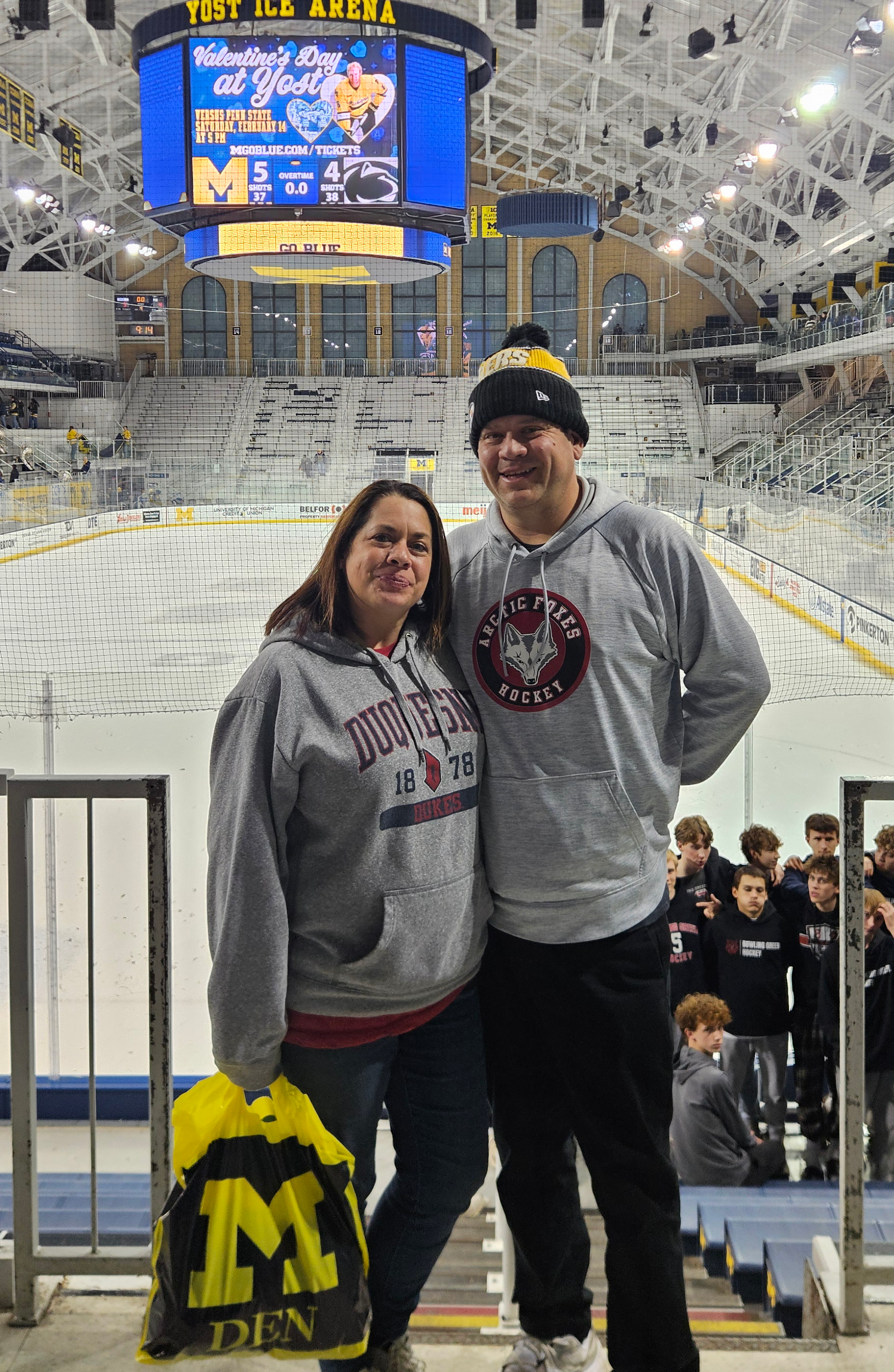 Brian and his wife at a hockey game