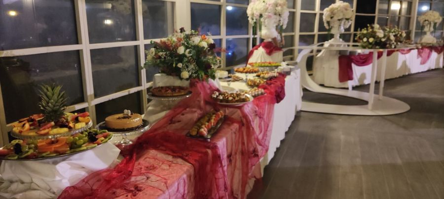 Tavolo con fiori, buffet e tovaglia rossa