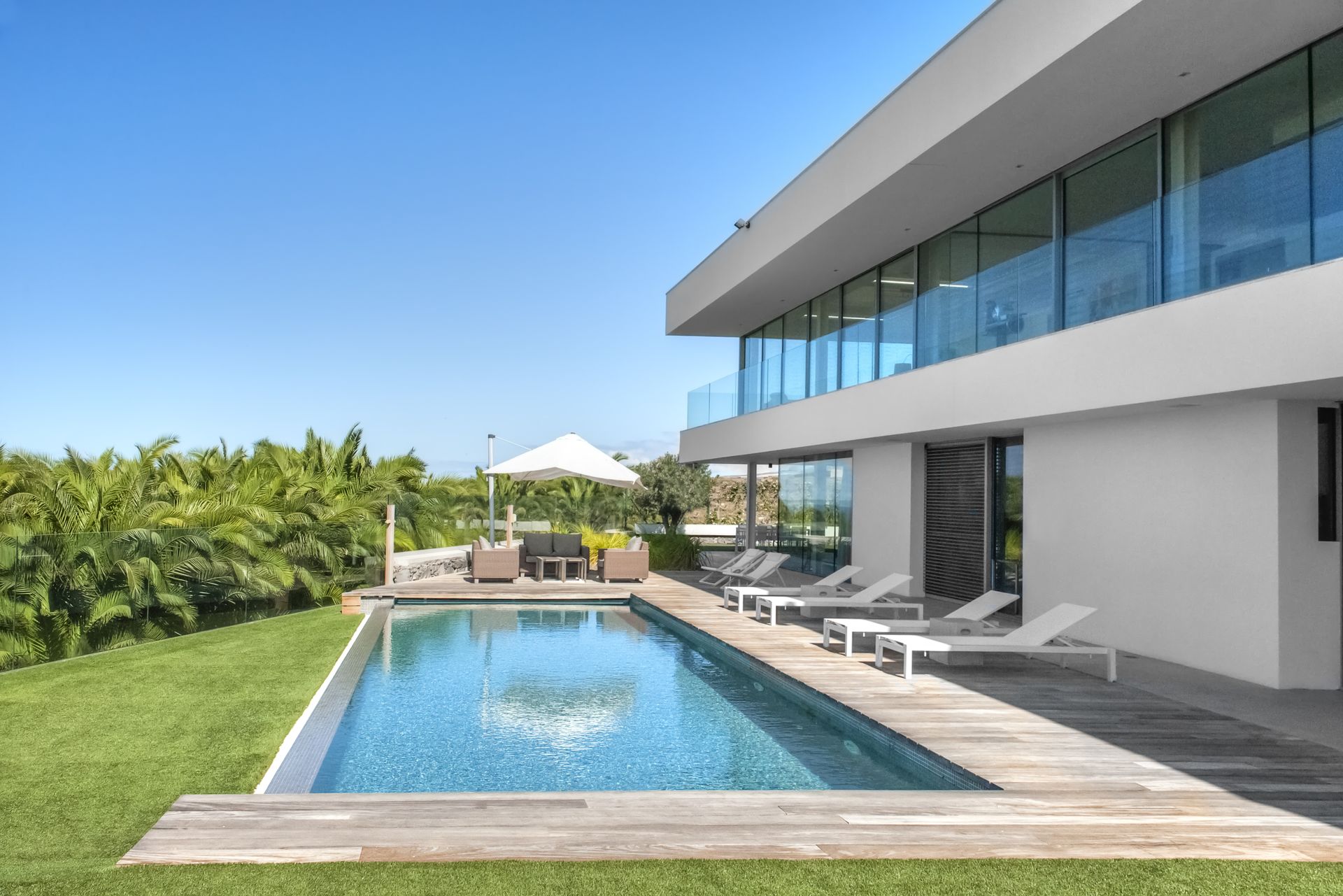 A large house with a large swimming pool in front of it