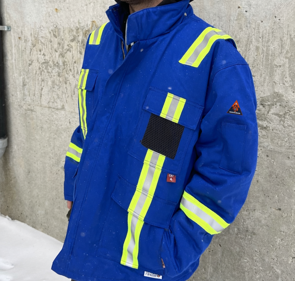 Red work jacket with reflective stripes and patches.