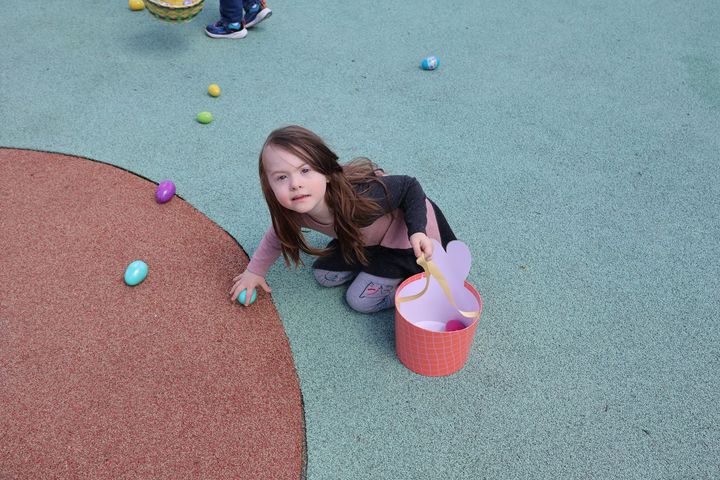 A young girl finding easter eggs at the Easter Egg Hunt!