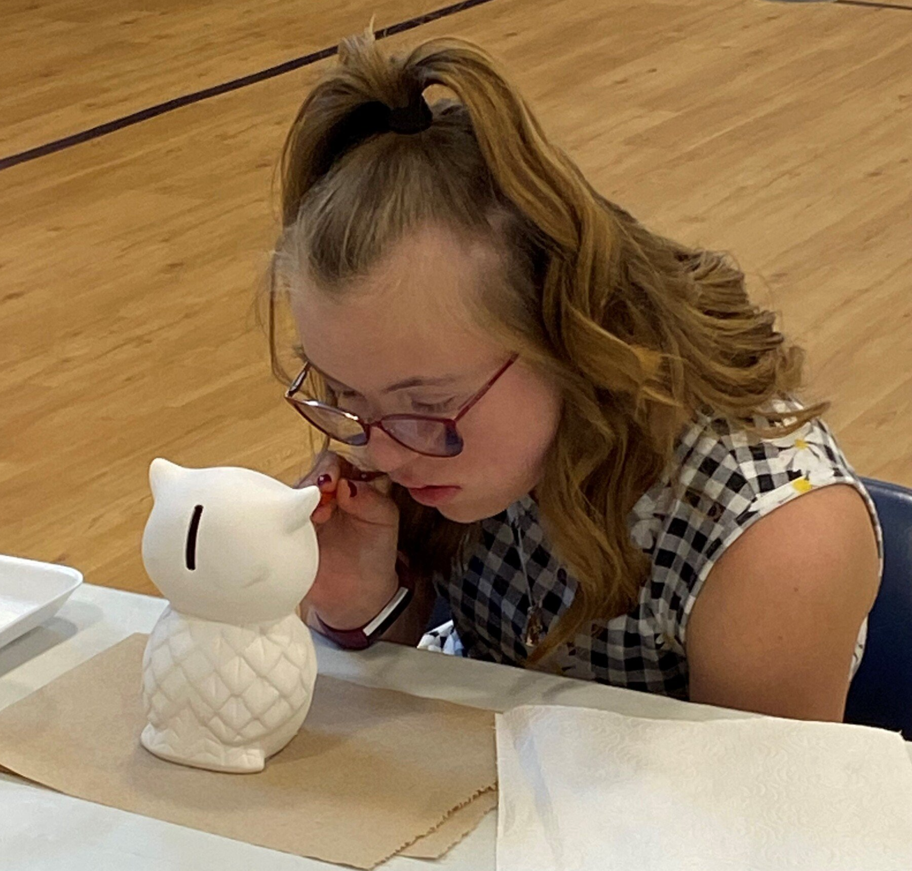 A young girl concentrates as she paints an owl at a Rec Night