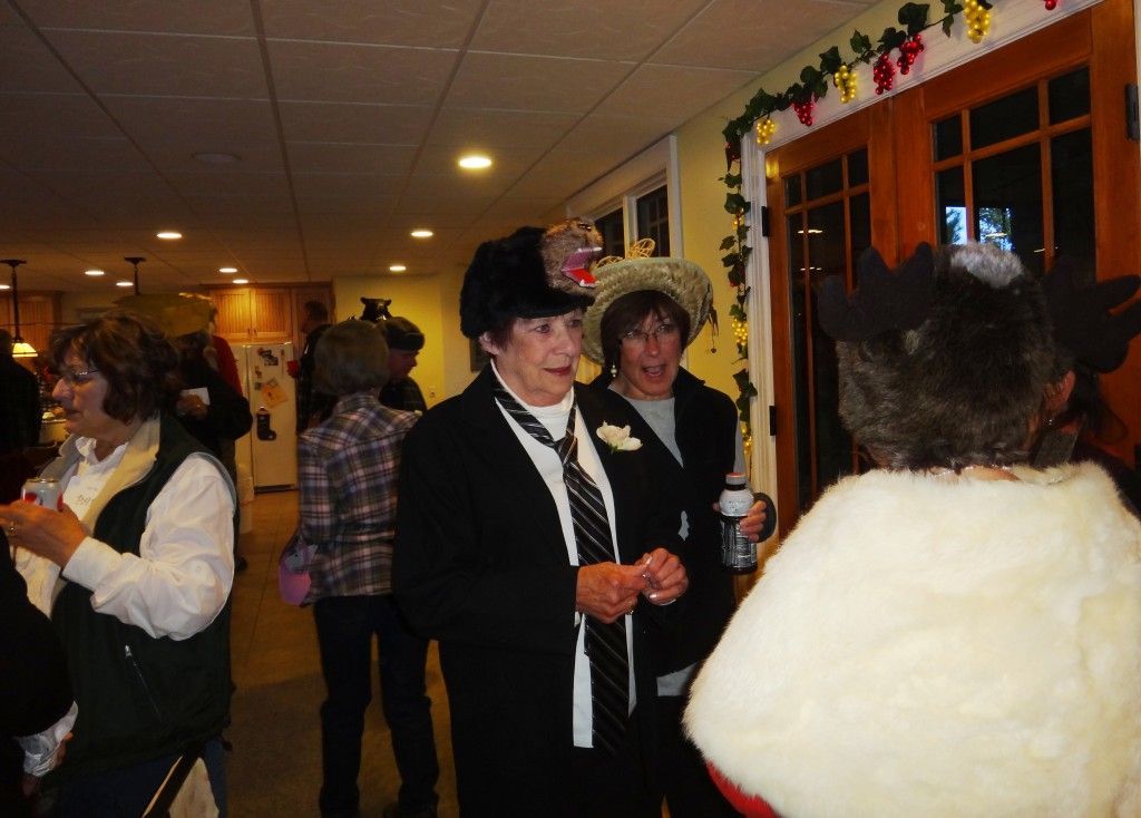 A group of women are standing in a room talking.