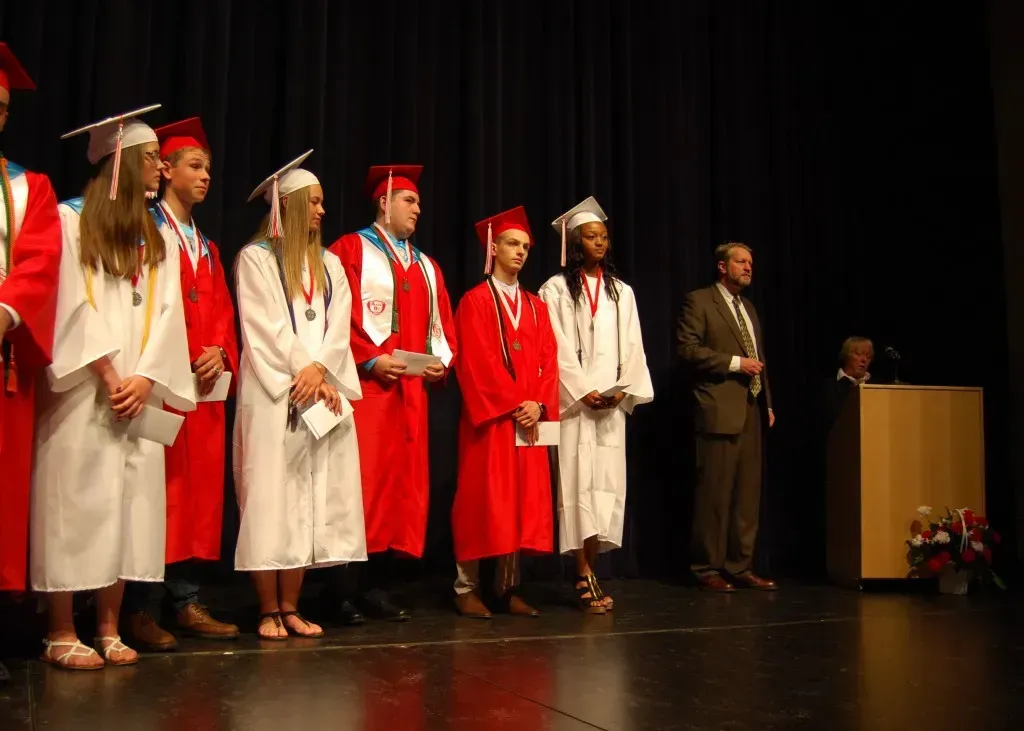 A group of graduates are standing on a stage.