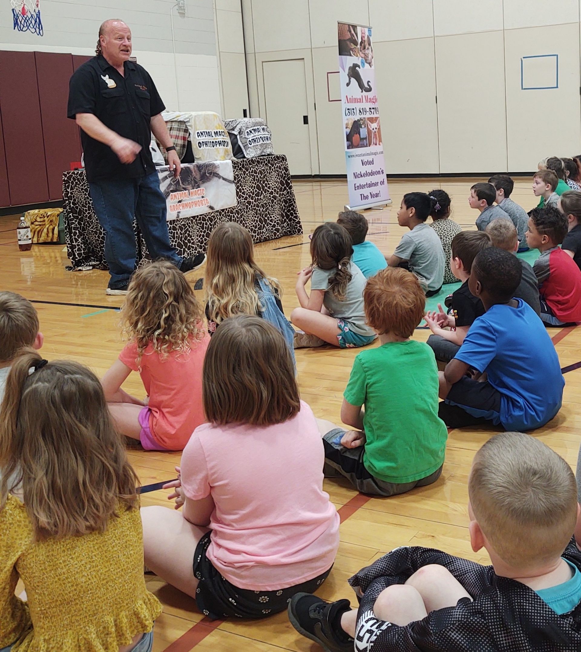 A man is giving a presentation to a group of children.