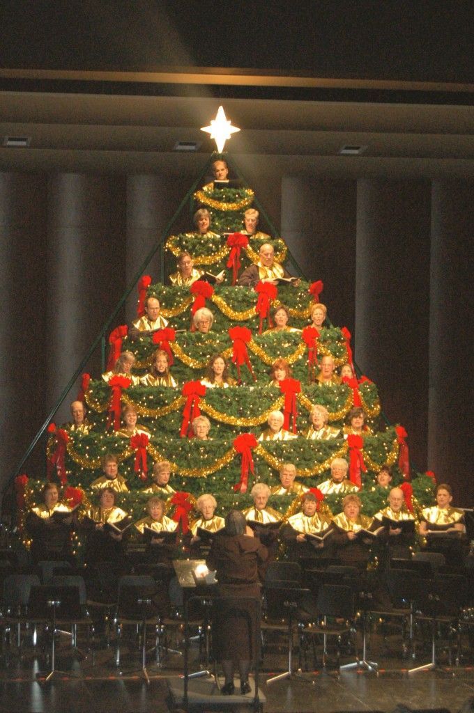 A choir singing from inside a Christmas tree.