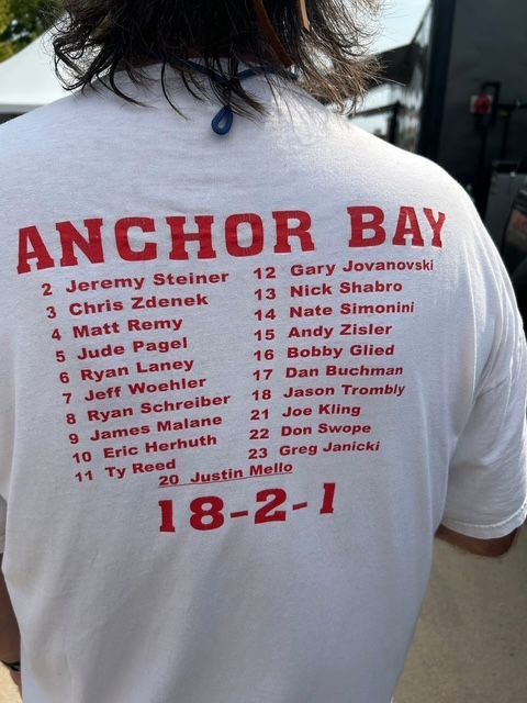 White t-shirt with red text. 