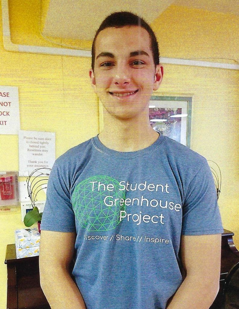 A man wearing a shirt that says The Student Greenhouse Project.