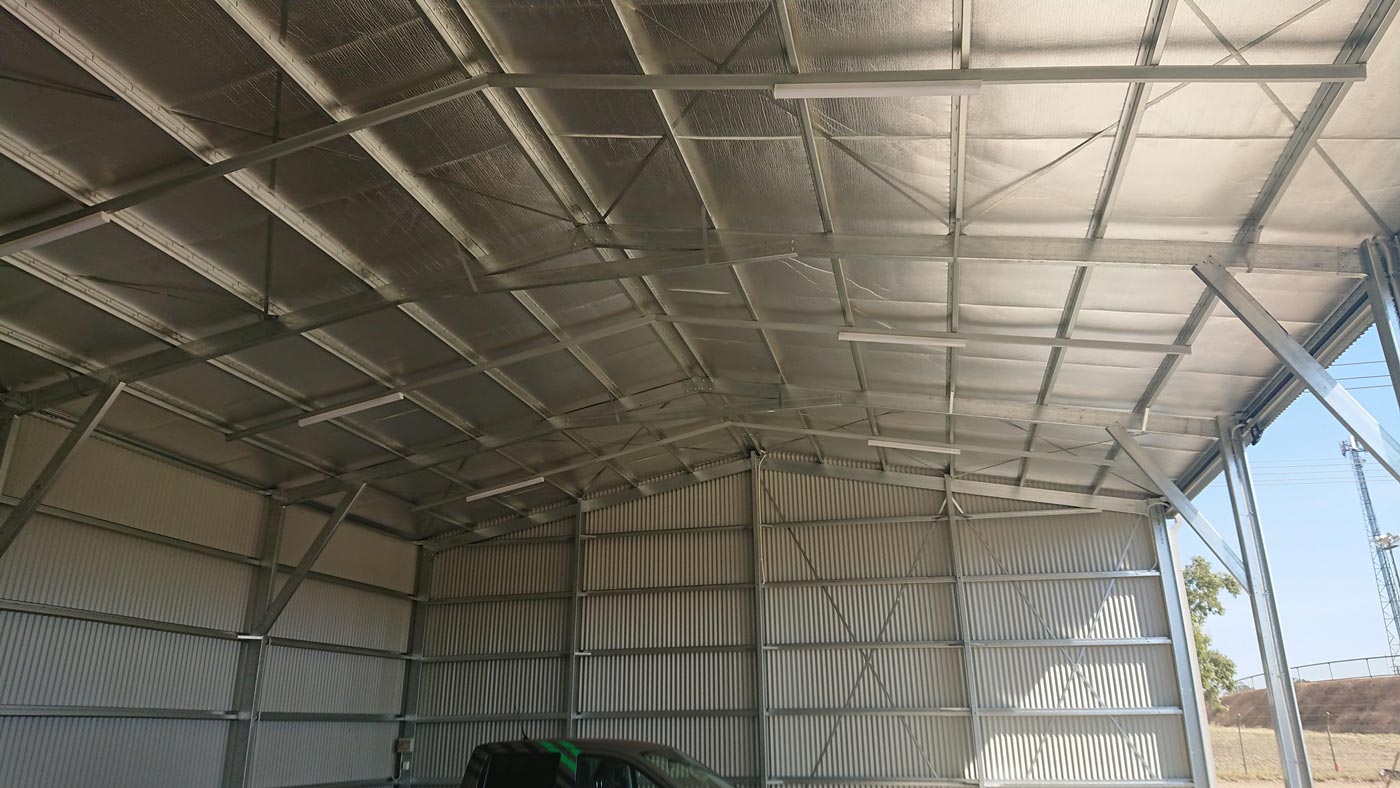A Large Metal Building With A Roof That Is Covered In Insulation — Alice Sheds & Structures In Ciccone, NT