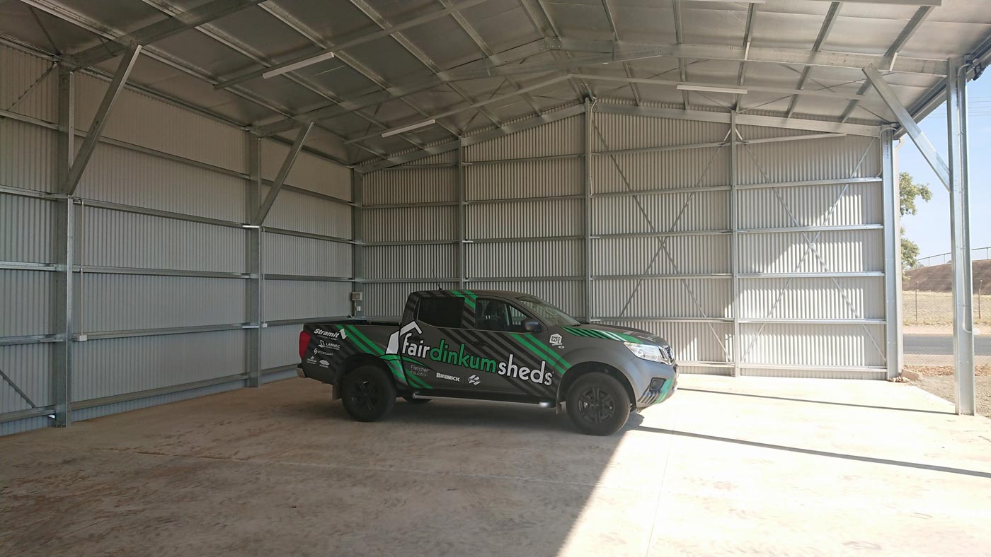 A Truck Is Parked Inside Of A Metal Building — Alice Sheds & Structures In Ciccone, NT