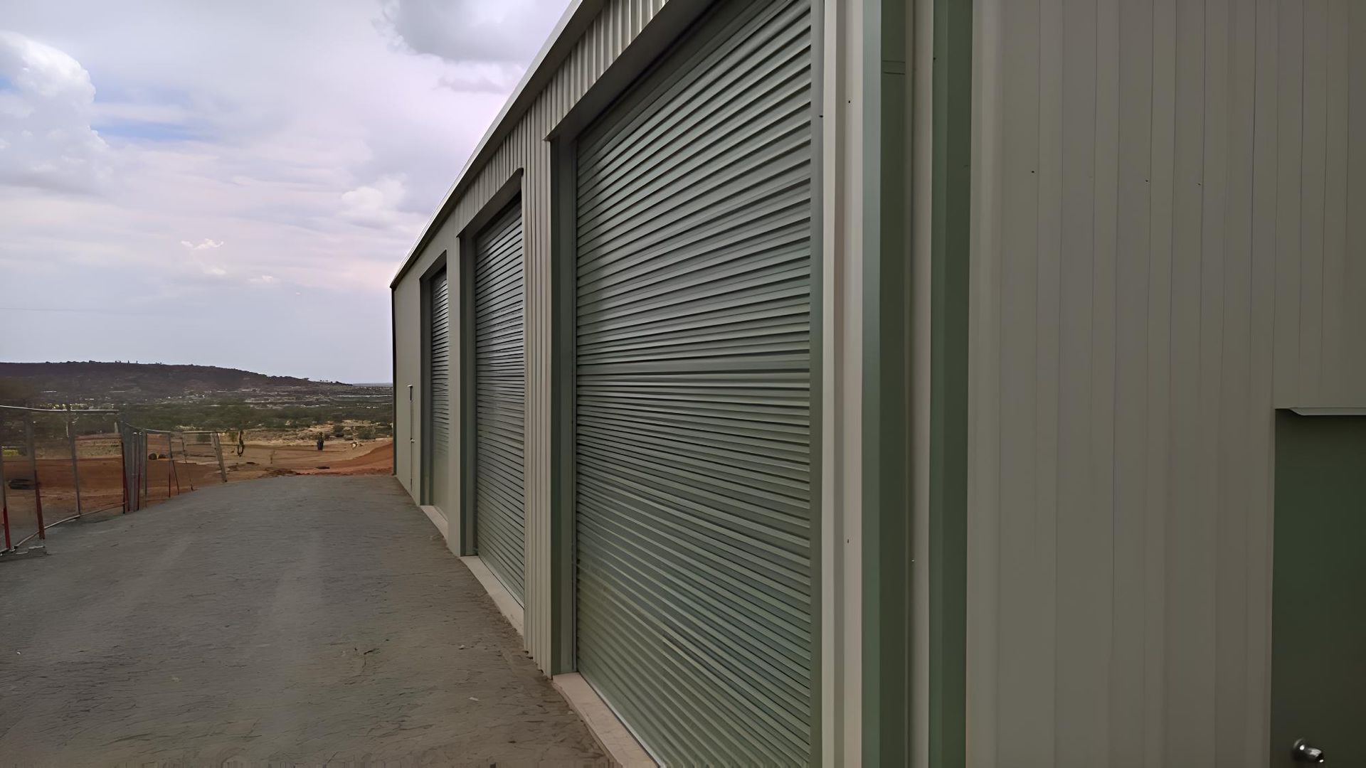 A Row Of Garage Doors With A View Of The Desert — Alice Sheds & Structures In Ciccone, NT