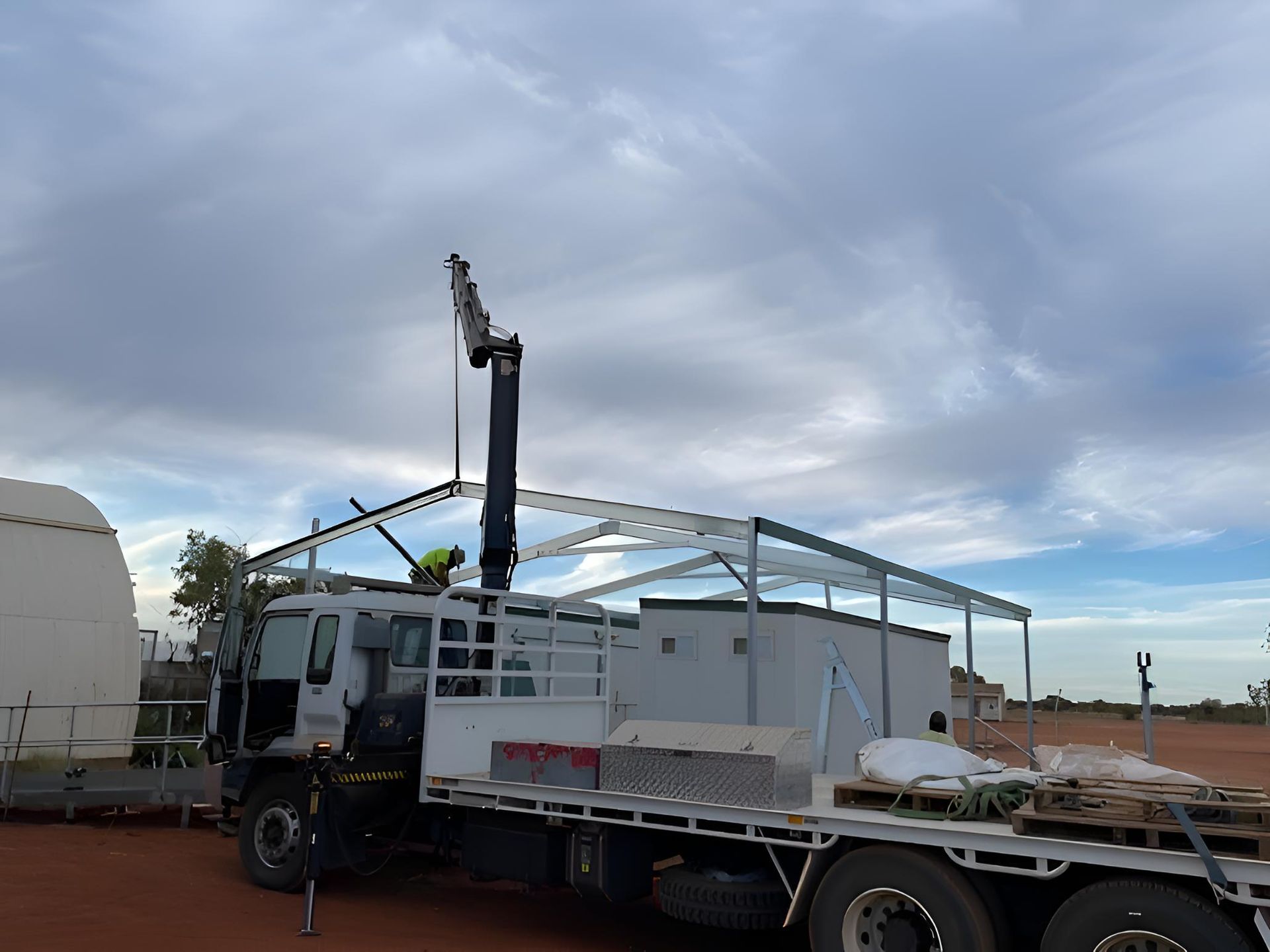 A Truck With A Crane Attached To The Back Of It — Alice Sheds & Structures In Ciccone, NT