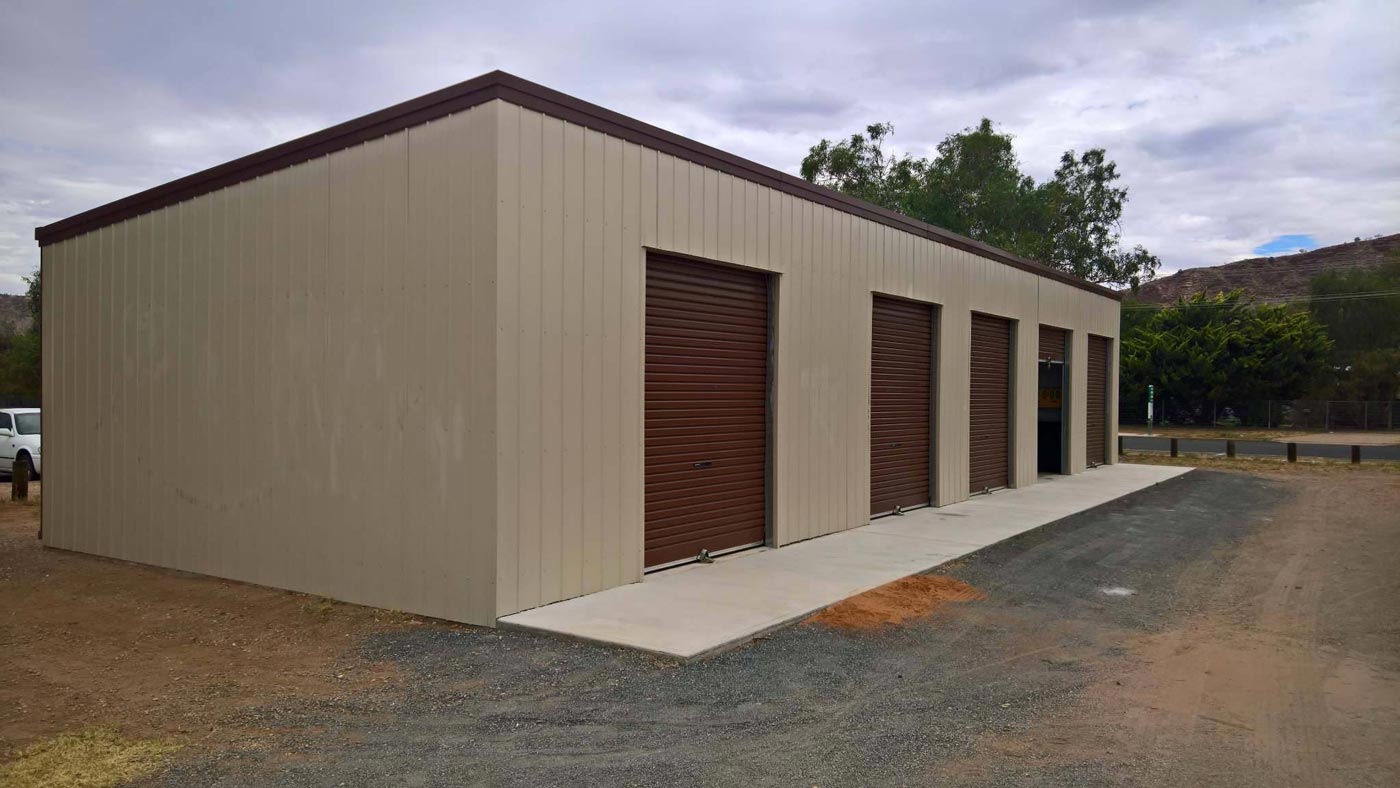 A Row Of Storage Units Are Lined Up Next To Each Other In A Parking Lot — Alice Sheds & Structures In Ciccone, NT