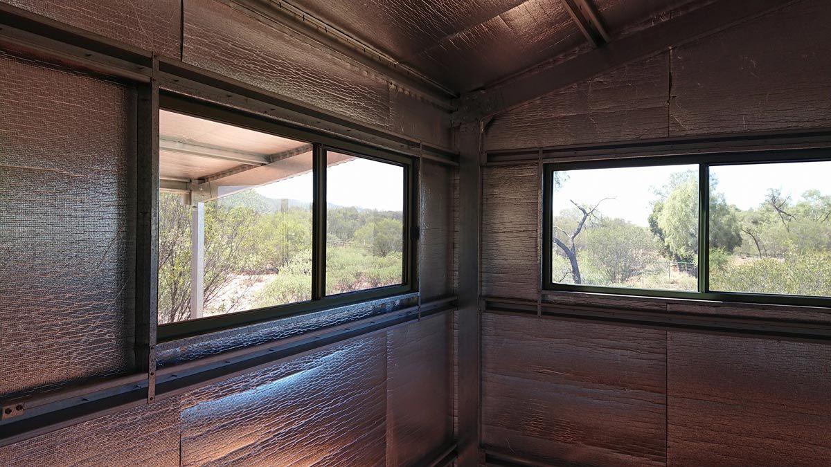 A Room With A Lot Of Windows And A View Of A Forest — Alice Sheds & Structures In Ciccone, NT