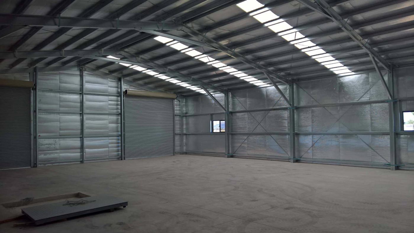 A Large Empty Warehouse With A Metal Roof And A Lot Of Windows — Alice Sheds & Structures In Ciccone, NT
