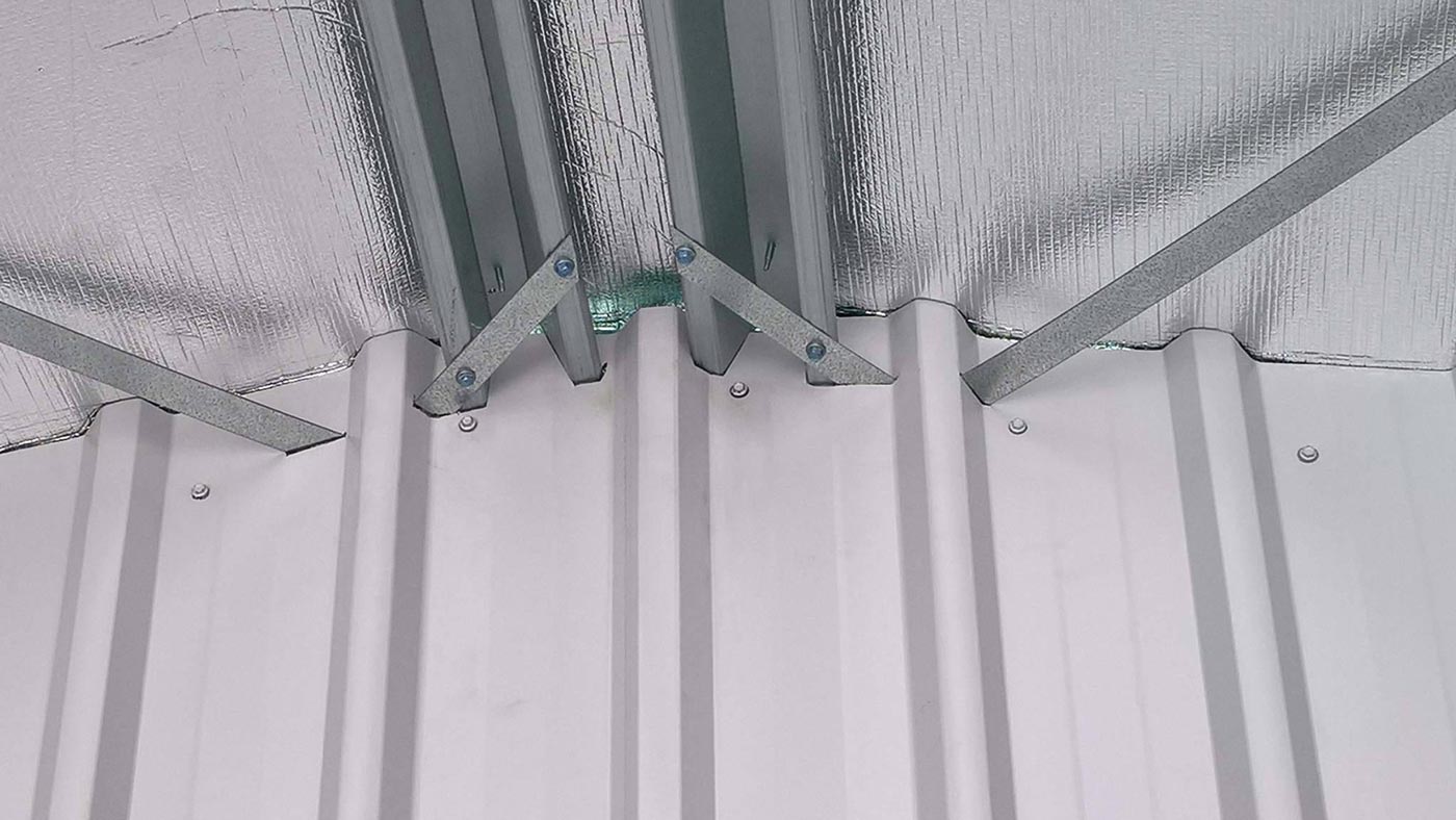 A Close Up Of A Metal Roof With A Green Light On It — Alice Sheds & Structures In Ciccone, NT