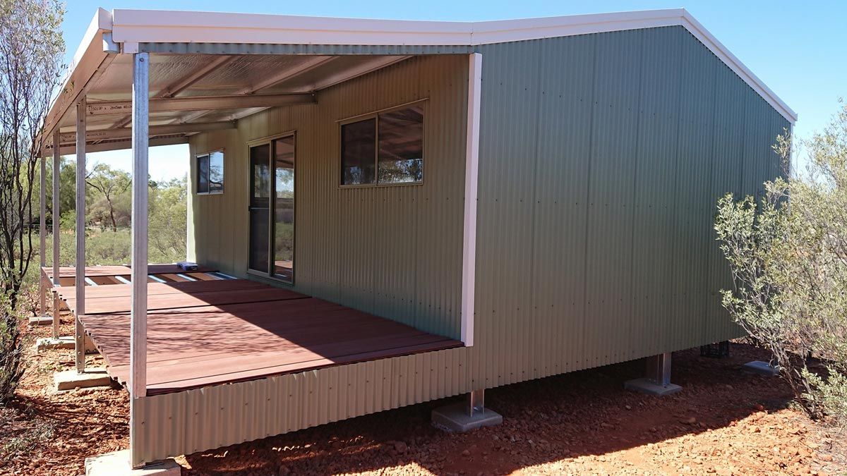 A Small House With A Porch And A Roof — Alice Sheds & Structures In Ciccone, NT