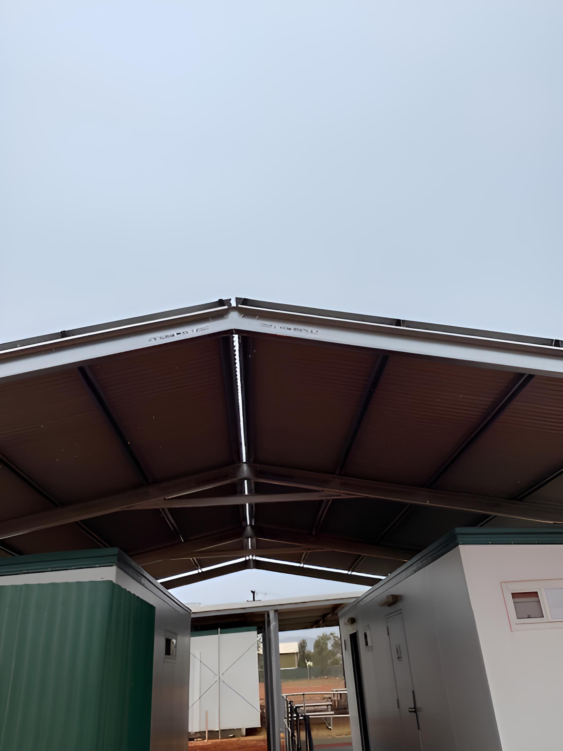 A Roof Of A Building With A Blue Sky In The Background — Alice Sheds & Structures In Ciccone, NT