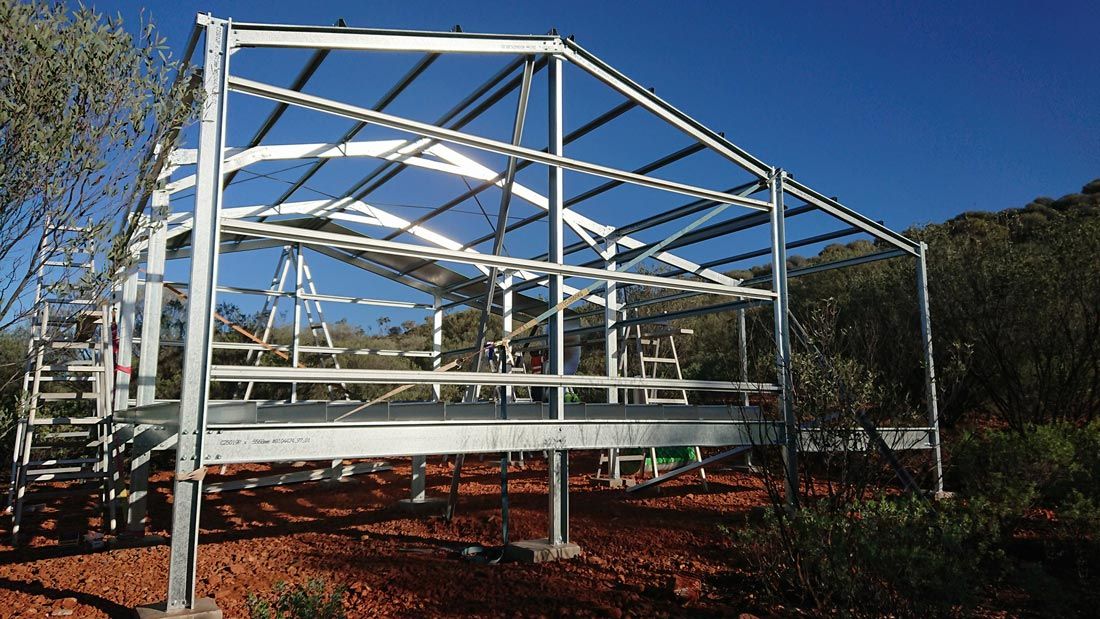A Large Metal Structure Is Being Built In The Middle Of A Field — Alice Sheds & Structures In Ciccone, NT